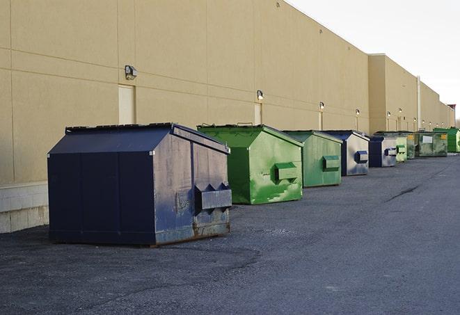 a stack of yellow construction dumpsters on a job site in Kane